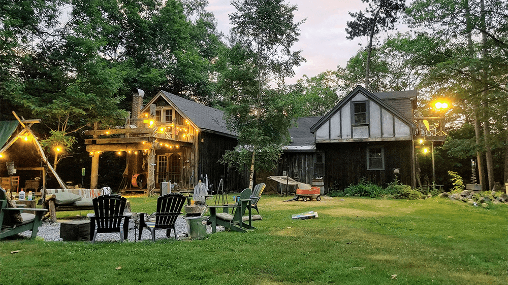 Backyard with yellow bug lights hung and installed throughout.